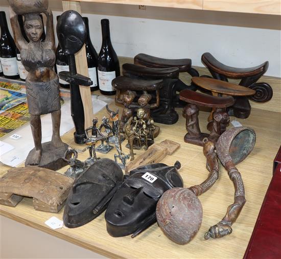 A quantity of African carvings including head-rests, masks and metalwares